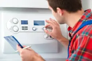 Technician servicing heating boiler